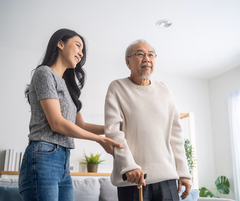 caregiver with parent walking with a cane - Milford elder law attorney concept