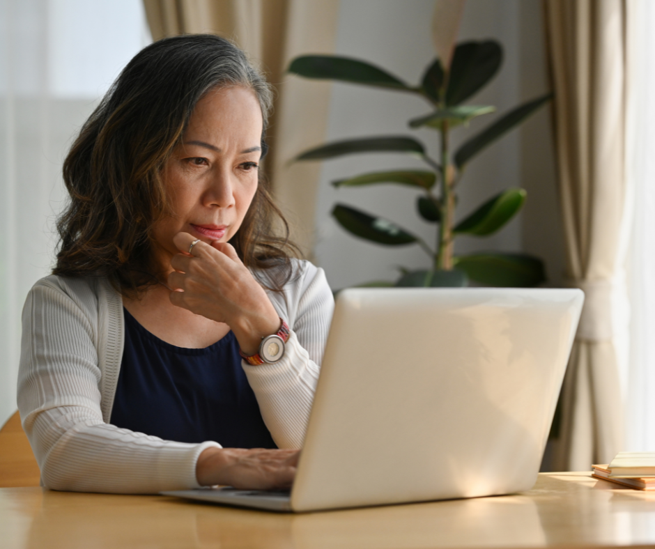 woman looking at laptop on desk - Trumbull estate planning attorney