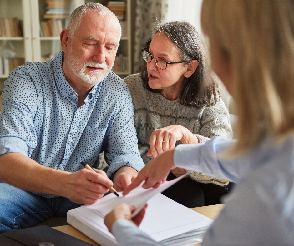 New Haven estate planning lawyer reviewing paperwork with clients 
