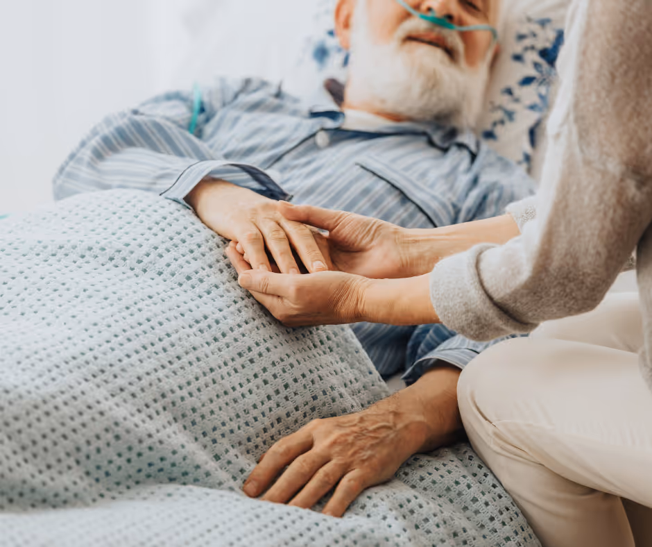 caregiver holding elderly man's hand - Trumbull will lawyer