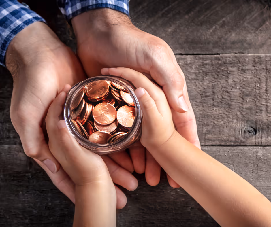 hands exchanging change in a glass jar - Trumbull will lawyer concept