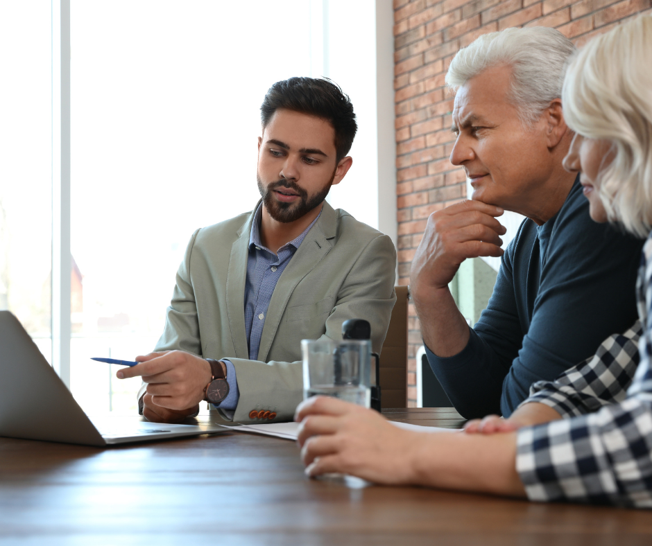 lawyer meeting with senior couple reviewing information - Milford Estate Planning concept