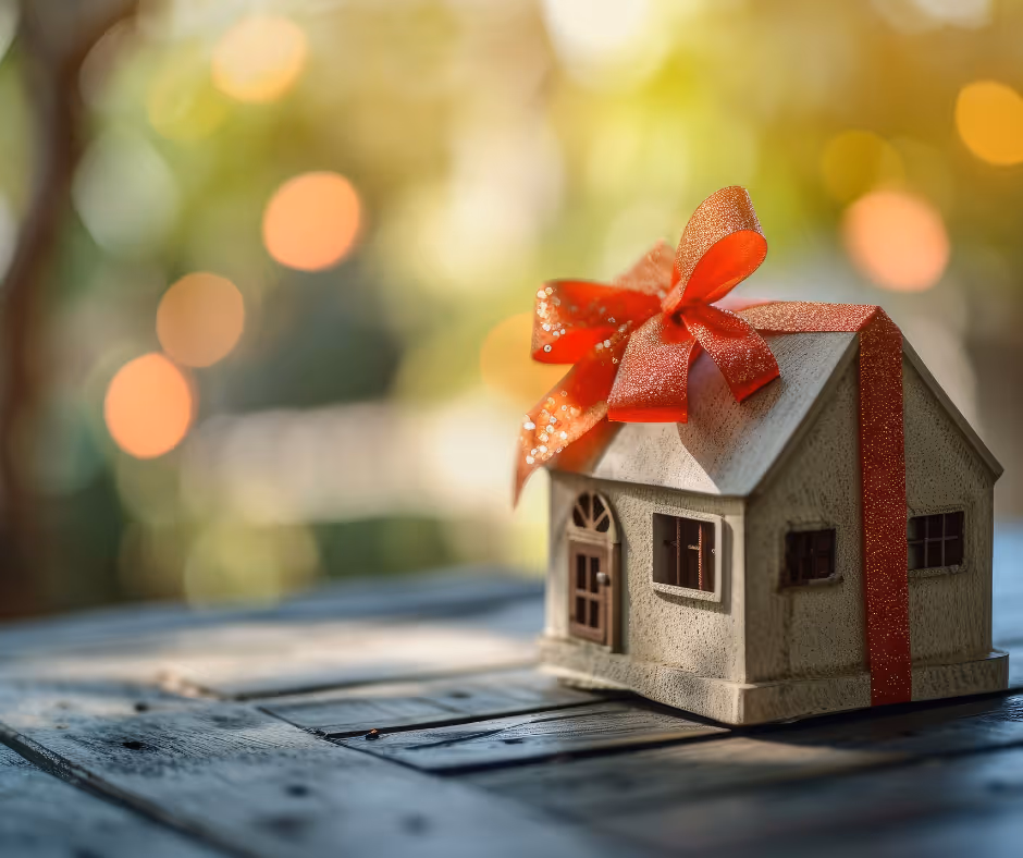 miniature house with ribbon on it on a wooden table - Milford estate attorney concept
