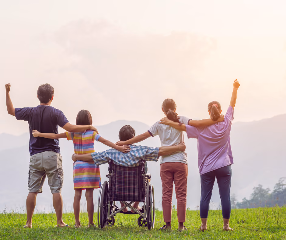 special needs family on hill raising their hands - special needs planning in Trumbull 