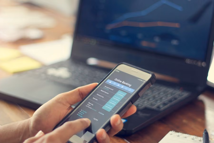 person on mobile phone near laptop - New Haven estate planning attorney