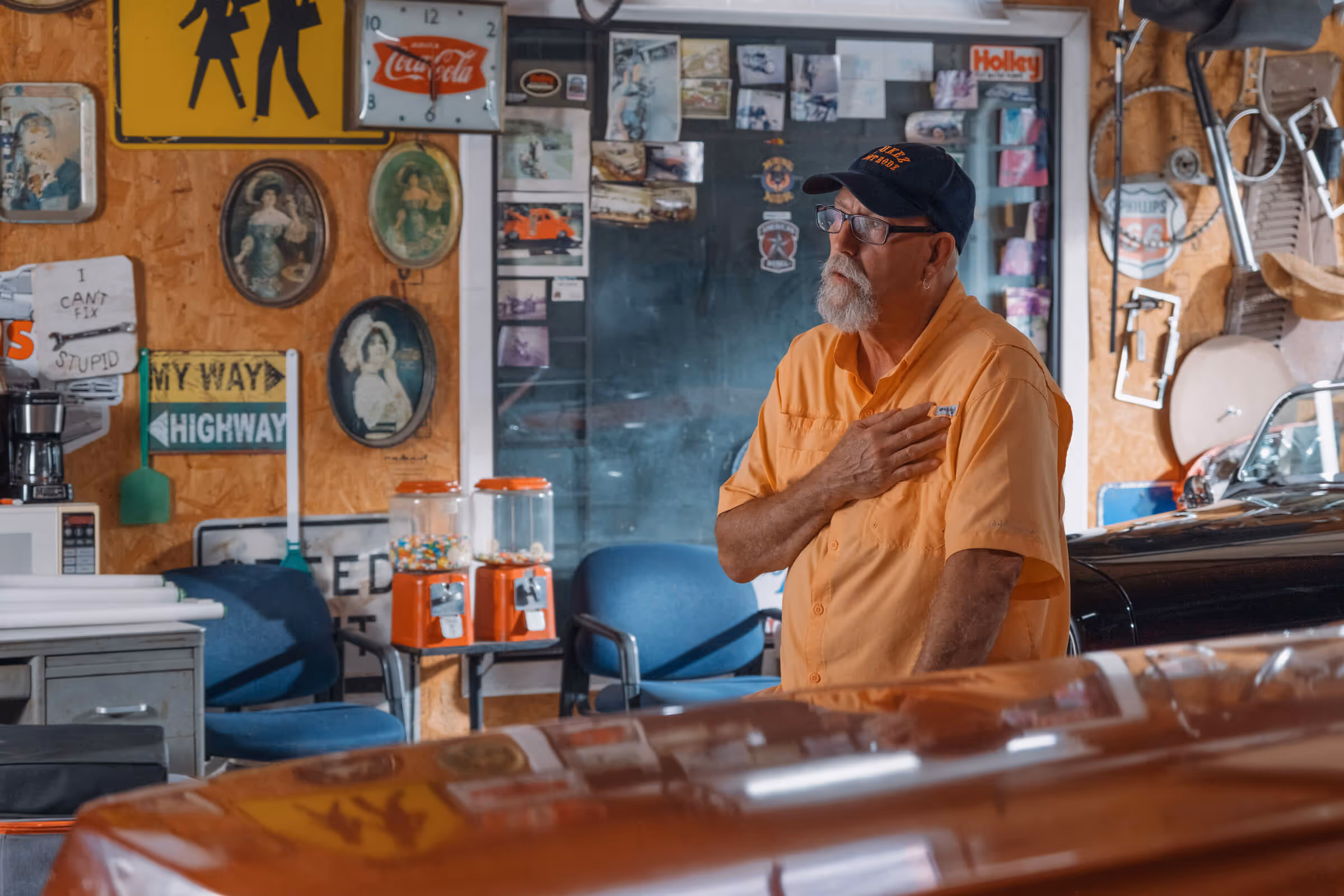 Man in cowboy hat looking at cloudy sky, black and white photo.