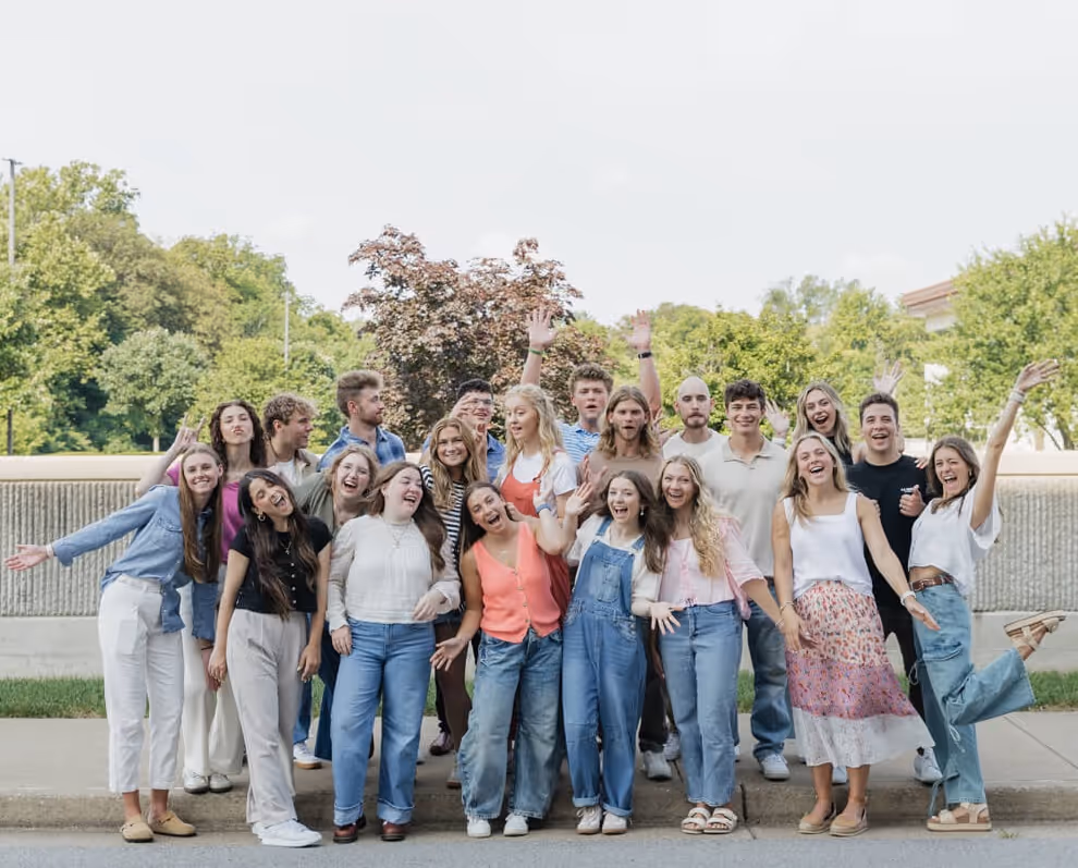 Smiling woman sitting in a church pew during a service.