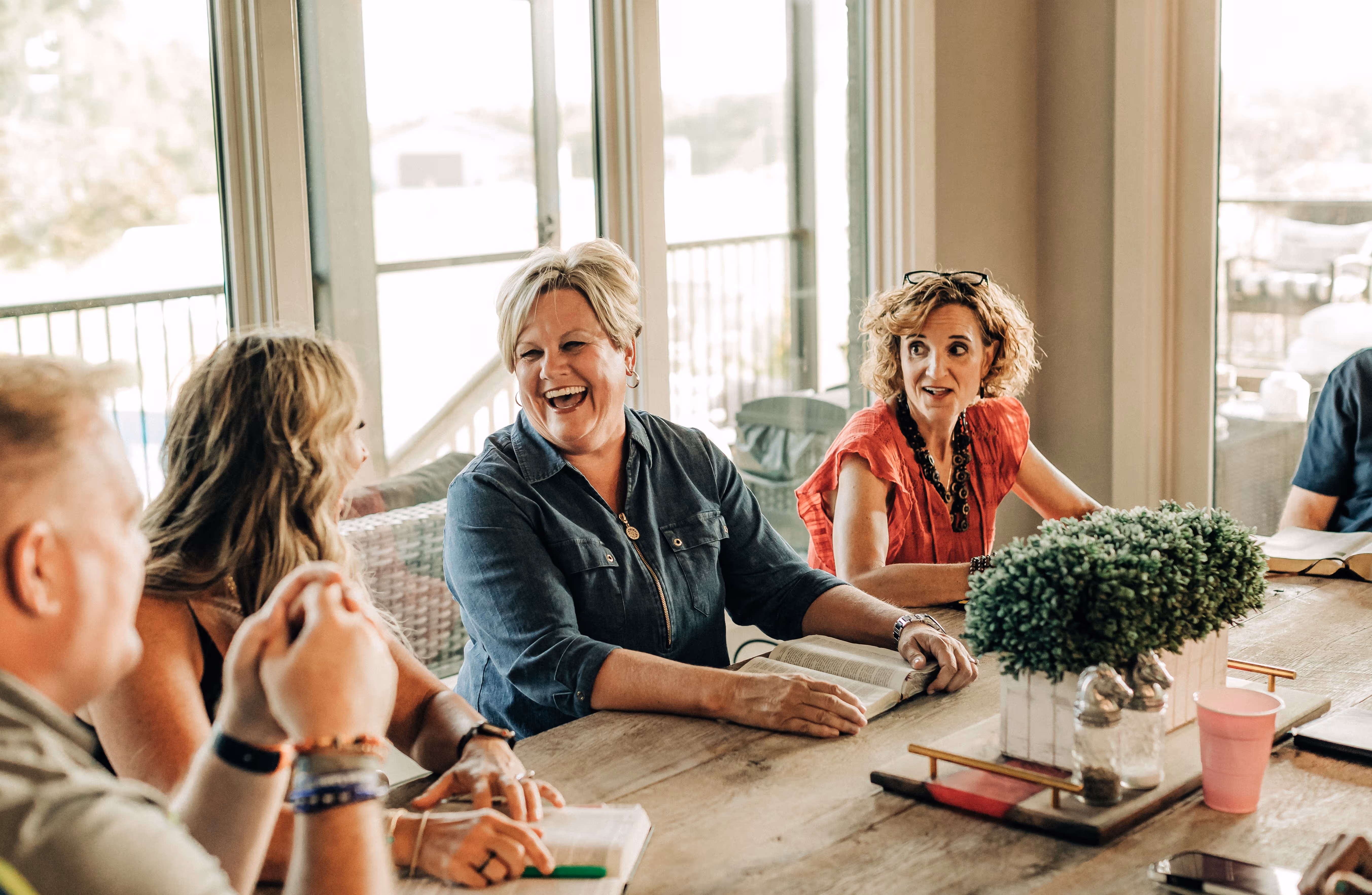 Group of friends laughing and enjoying a conversation.