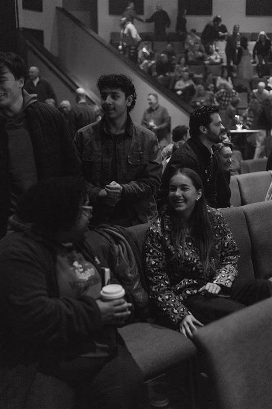 Young woman warmly greeting and embracing another person.