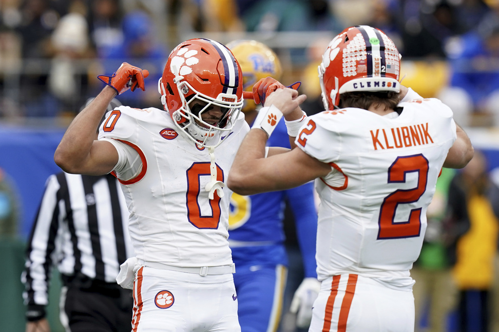 Clemson QB Cade Klubnik and WR Antonio Williams celebrate during a college football game. Klubnik and Williams are top CFB picks for Saturday, August 30, in the LSU vs. Clemson game.