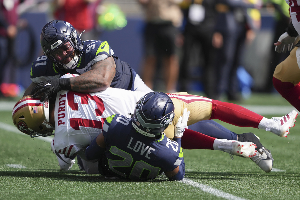 49ers QB Brock Purdy is sacked in an NFL game.