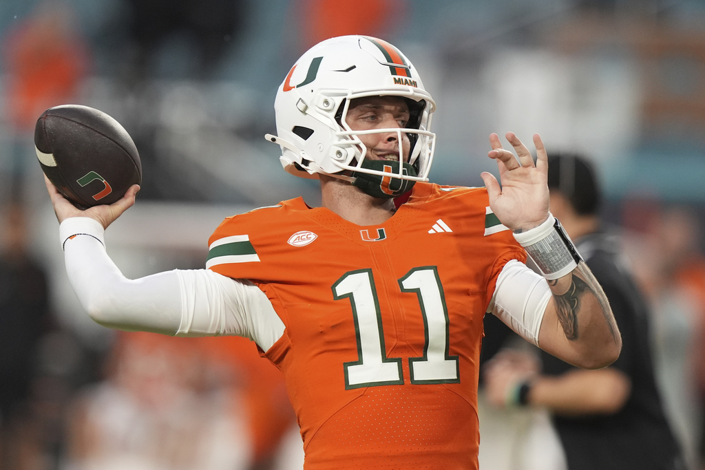 Miami QB Carson Beck throws a pass in a college football game.
