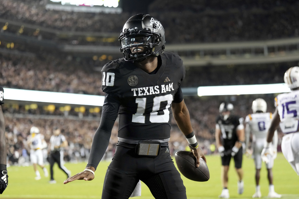Texas A&M QB Marcel Reed celebrates a touchdown in a college football game.