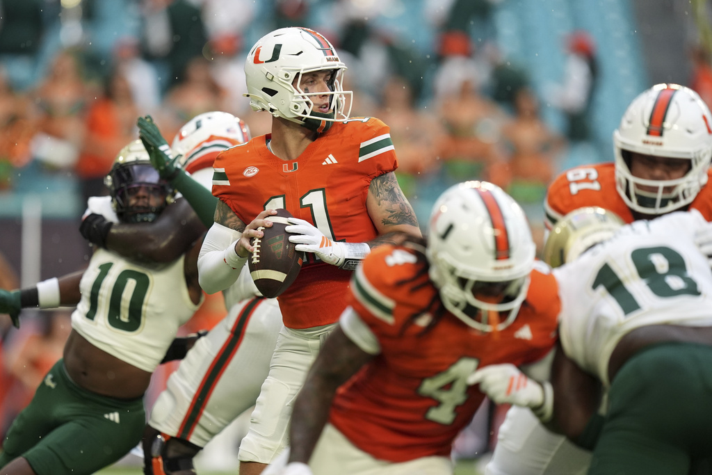 Miami QB Carson Beck throws a football during an NFL game.