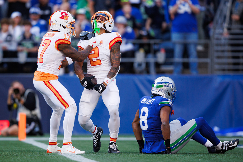 Bucs WR Emeka Egbuka celebrates a TD against the Seattle Seahawks. Egbuka injury update provided.