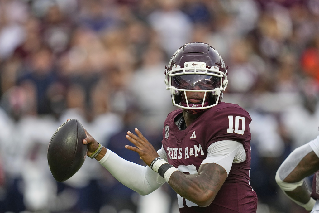 Texas A&M QB Marcel Reed drops back to pass during a college football game.
