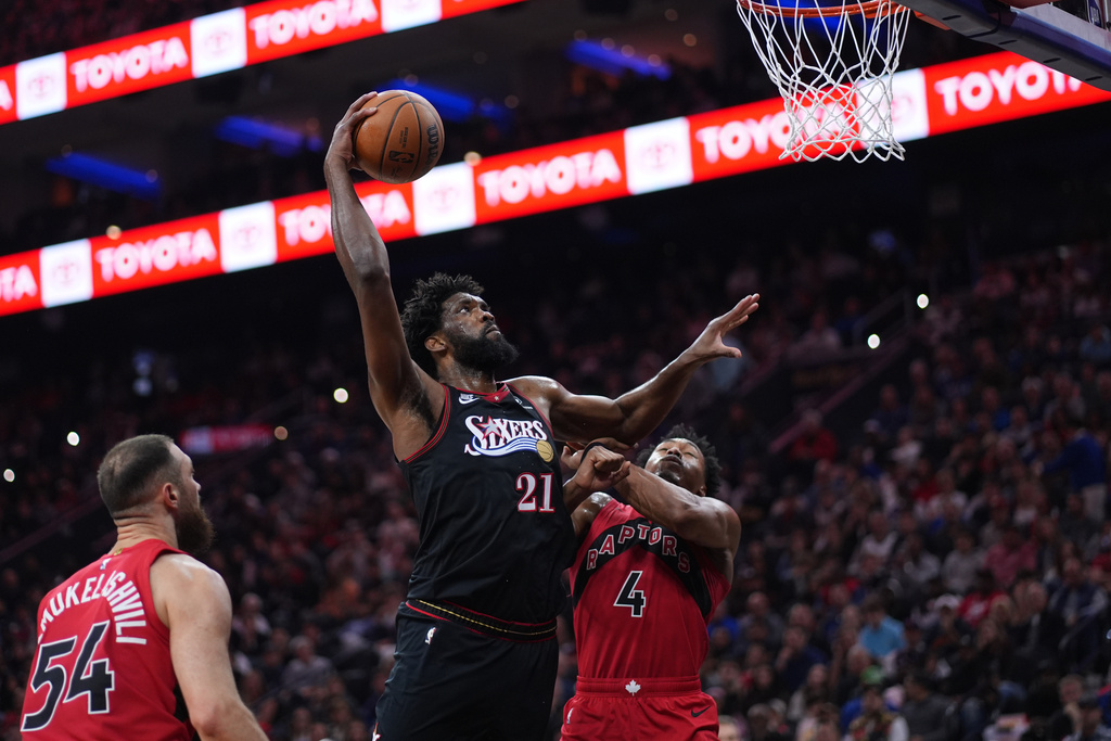 76ers C Joel Embiid dunks a basketball in an NBA game.