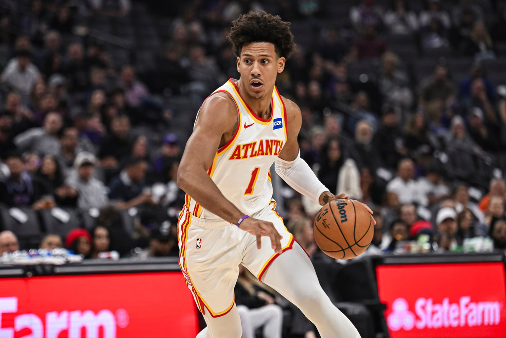 Hawks F Jalen Johnson dribbles a basketall in an NBA game.