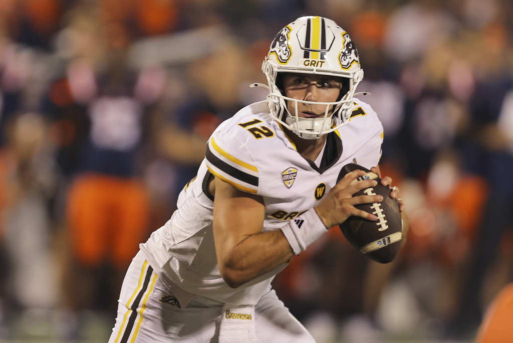 Western Michigan QB Broc Lowry drops back to pass in a college football game.