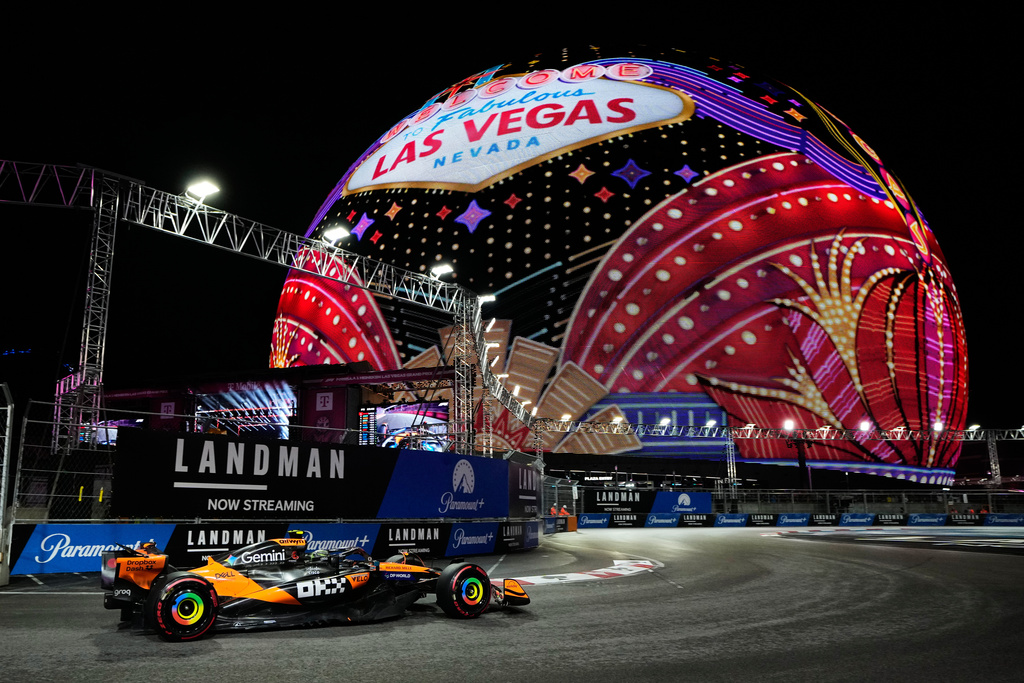 F1 driver Lando Norris of Team McLaren drives past The Sphere at a F1 Las Vegas GP pracice session.