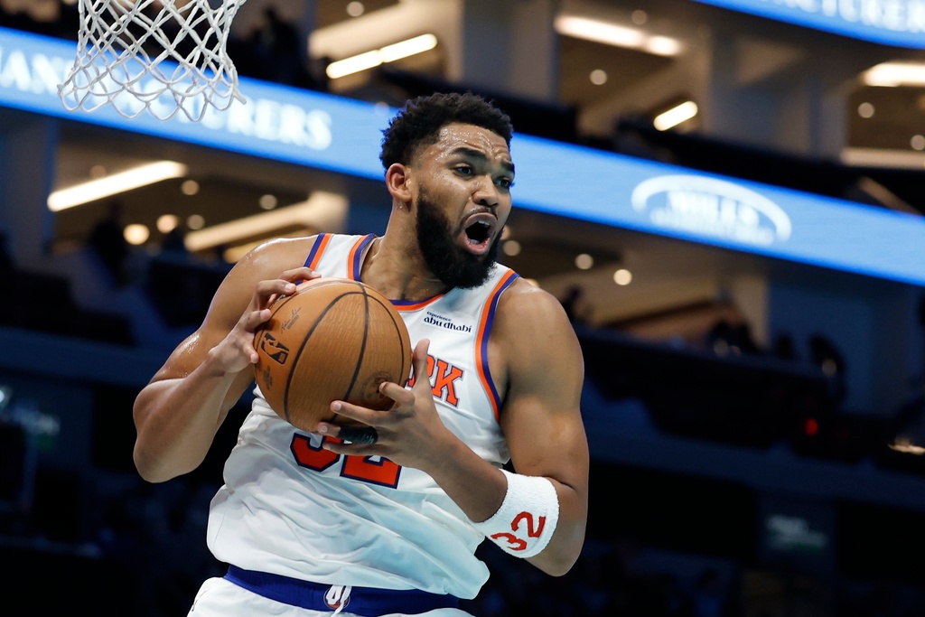 New York C Karl-Anthony Towns grabs a rebound in an NBA game.