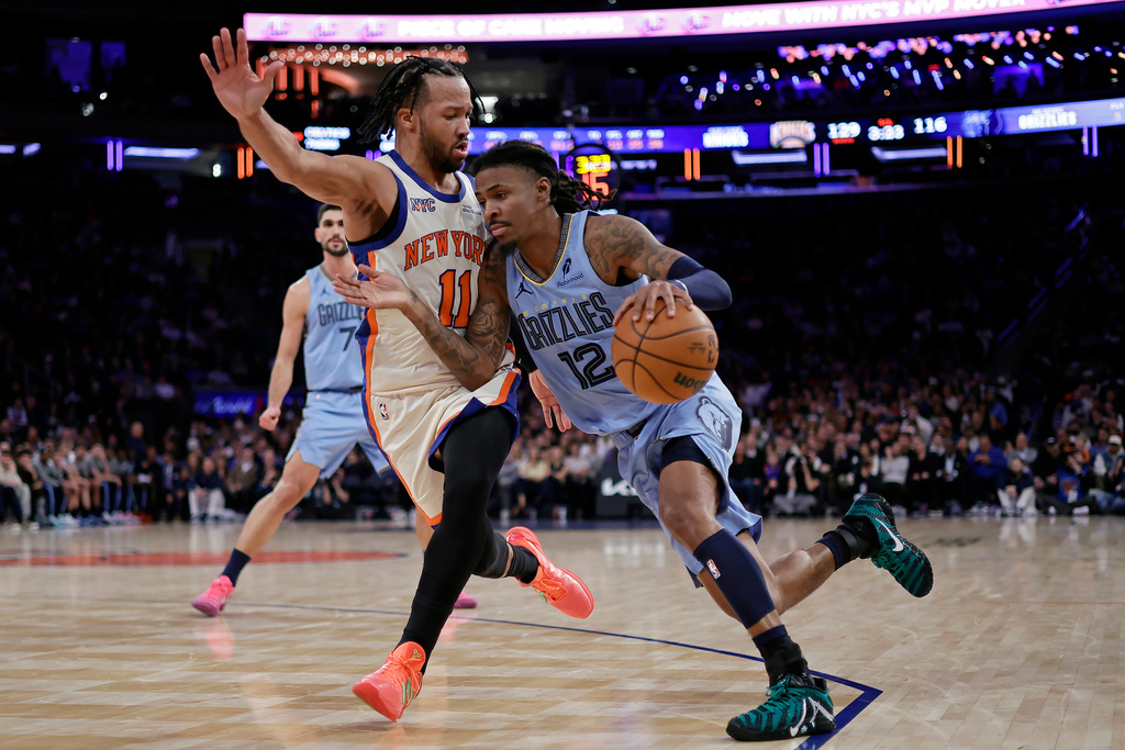 Grizzlies PG Ja Morant drives to the basket in an NBA game. Ja Morant is out for the Grizzlies vs. Spurs game on Tuesday, December 2.