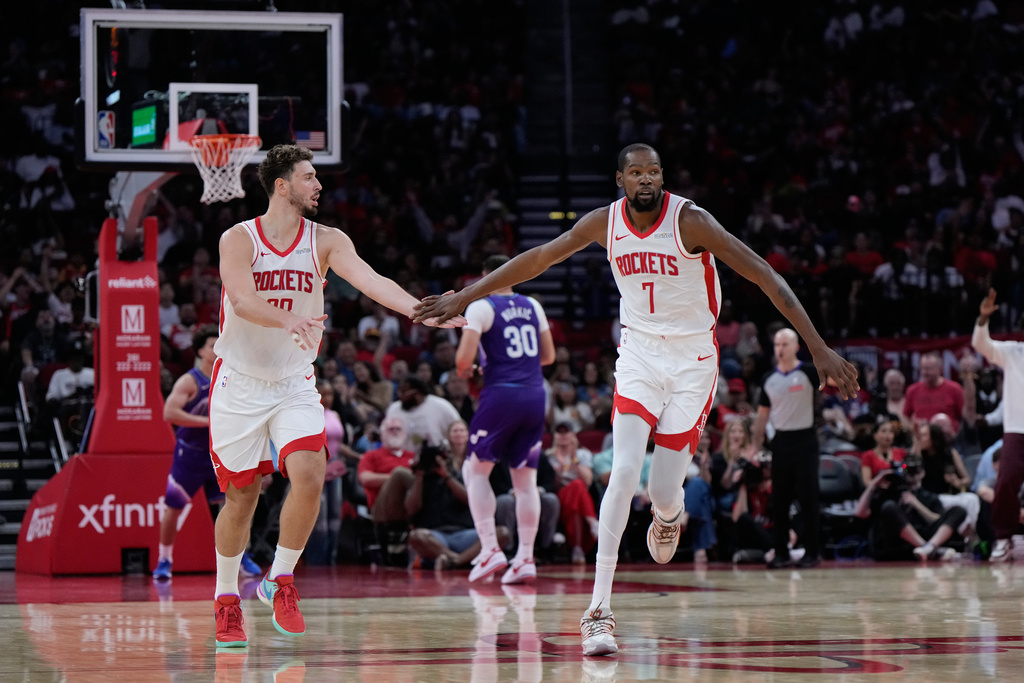Rockets F Kevin Durant and C Alperen Sengun celebrate at an NBA game.