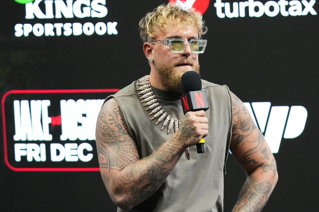 Boxer Jake Paul talks on the microphone at a Jake Paul vs. Anthony Joshua press conference put on by Netflix.