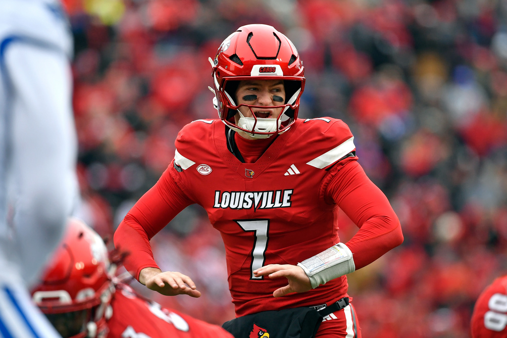 Louisville Cardinals QB Miller Moss adjusts at the line of scrimmage against Kentucky.