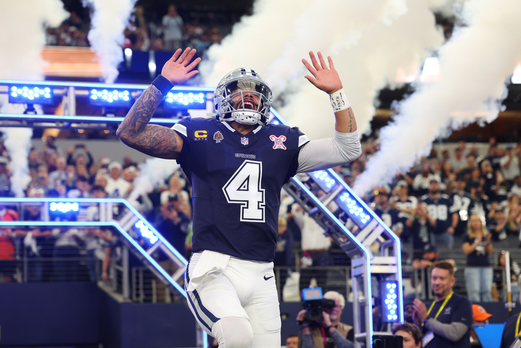 Cowboys QB Dak Prescott runs out of the tunnel before an NFL game.