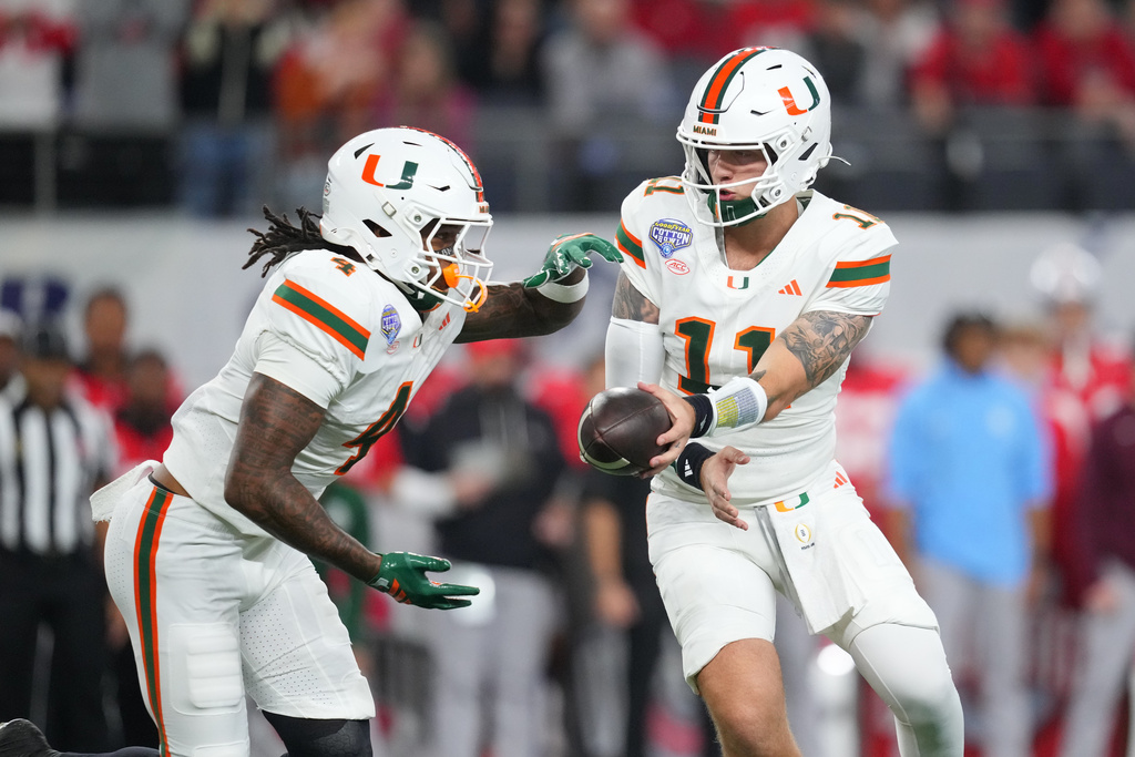 Miami Hurricanes QB Carson Beck hands the ball off to RB Mark Fletcher Jr. in the Cotton Bowl against Ohio State.