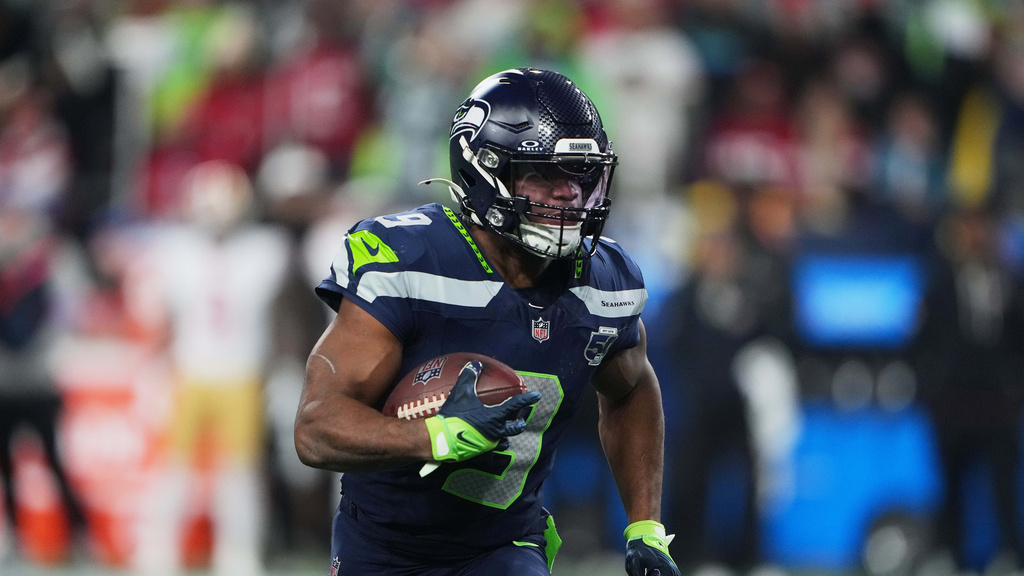 Seattle Seahawks RB Kenneth Walker III runs with the ball against the San Francisco 49ers in a playoff game.