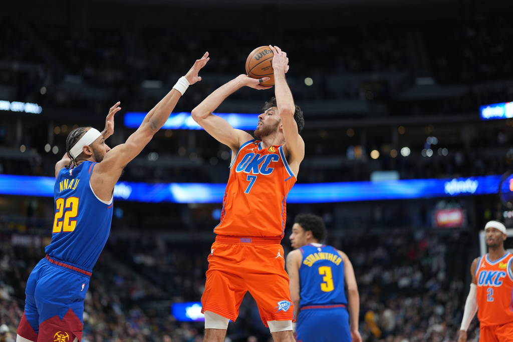 Thunder C Chet Holmgren shoots a basketball in an NBA game.
