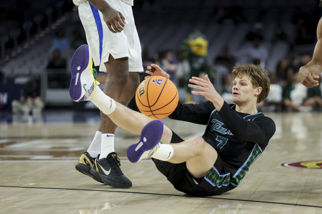 Tulane G Rowan Brumbaugh dives for a basketball in a CBB game.