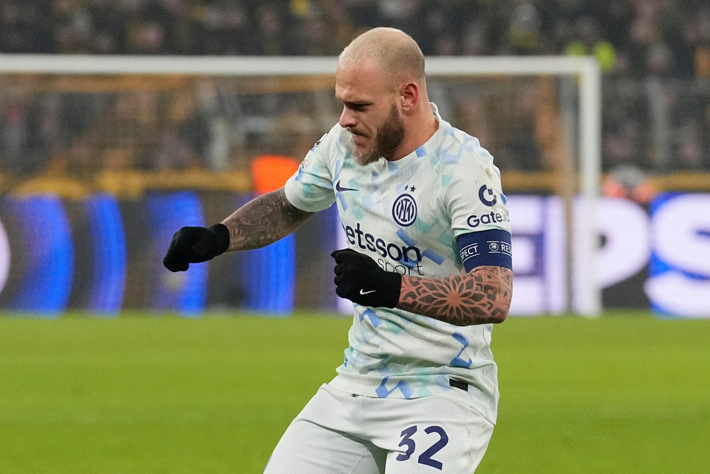 Inter Milan's Federico Dimarco celebrates after scoring a goal in a Champions League game.