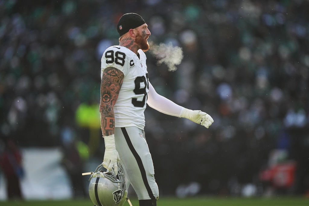 Raiders DE Maxx Crosby walks off the field in an NFL game.
