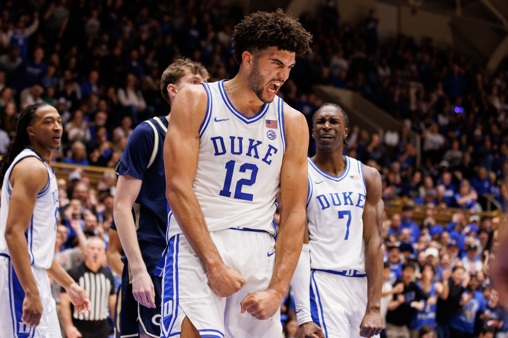Duke's Cameron Boozer and Dame Sarr react after a play during the second half of an NCAA college basketball game.