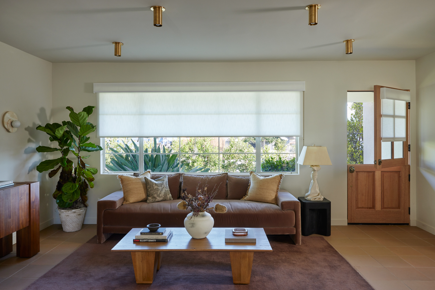 Living room with drop down shades on windows and doors
