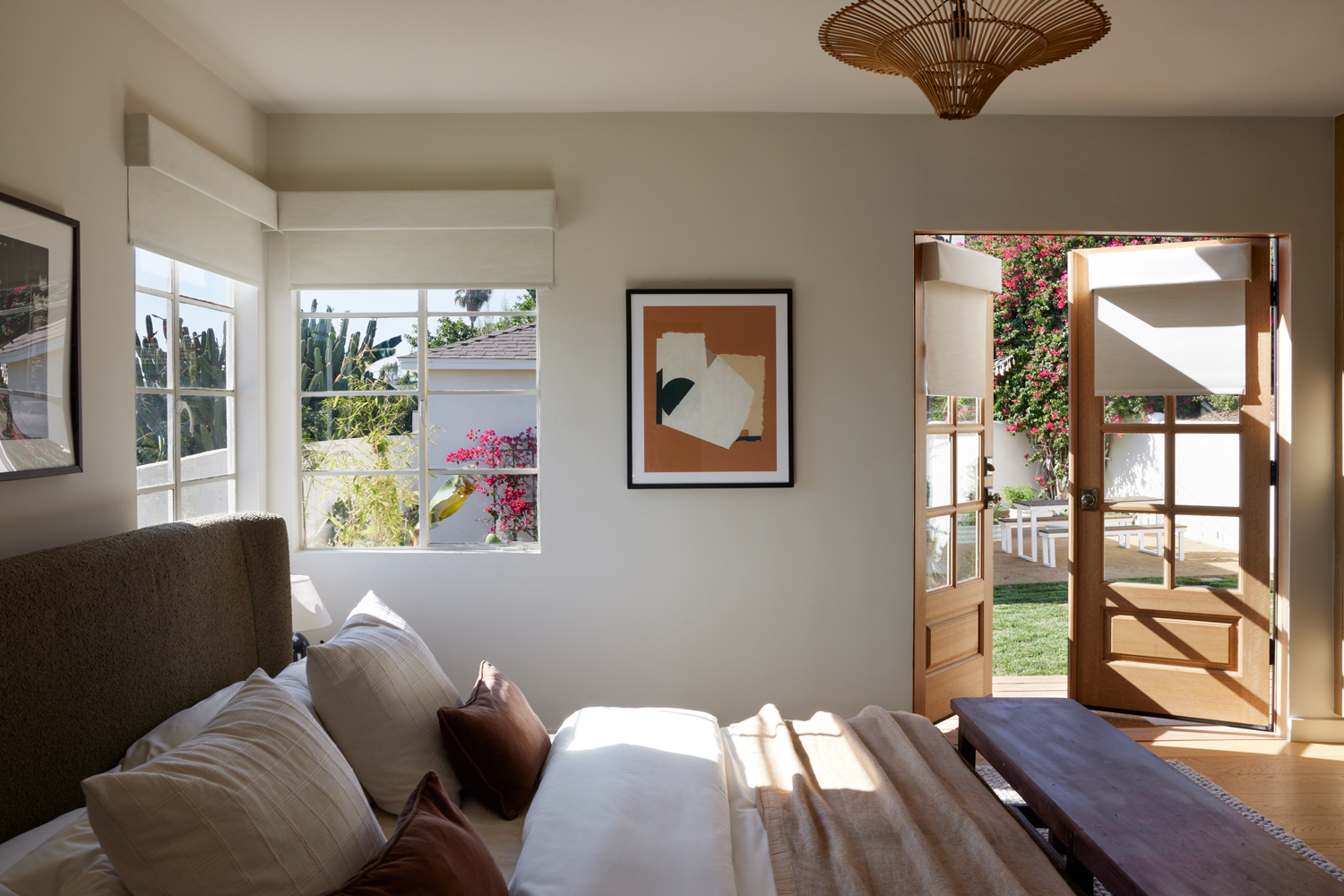 Bedroom with drop down shades on windows and doors