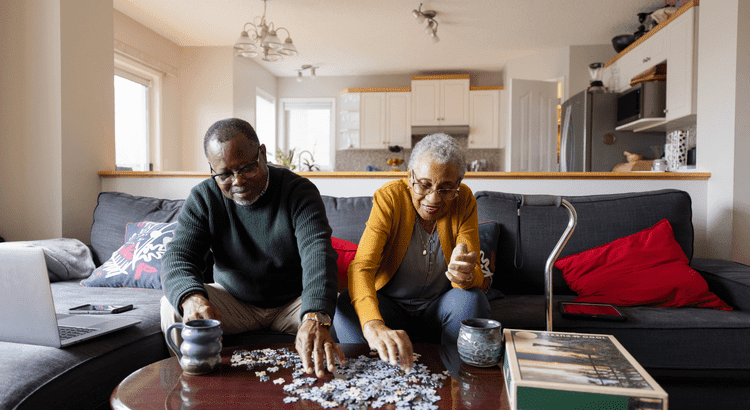 Older couple doing a puzzle on a table