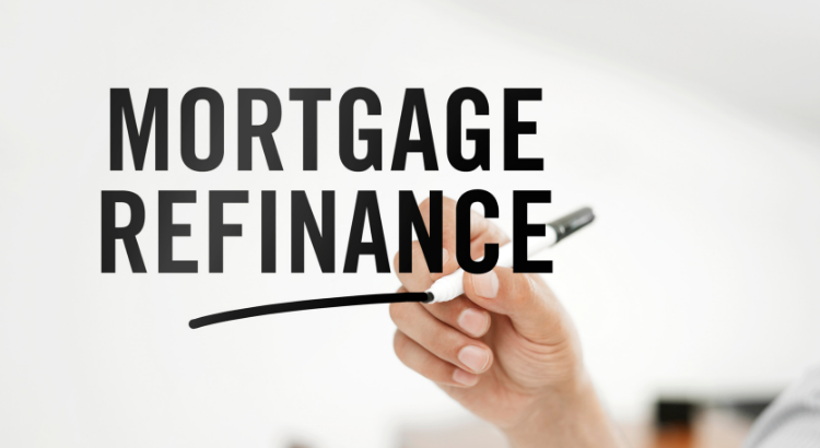 Hand holding pen with words mortgage refinance