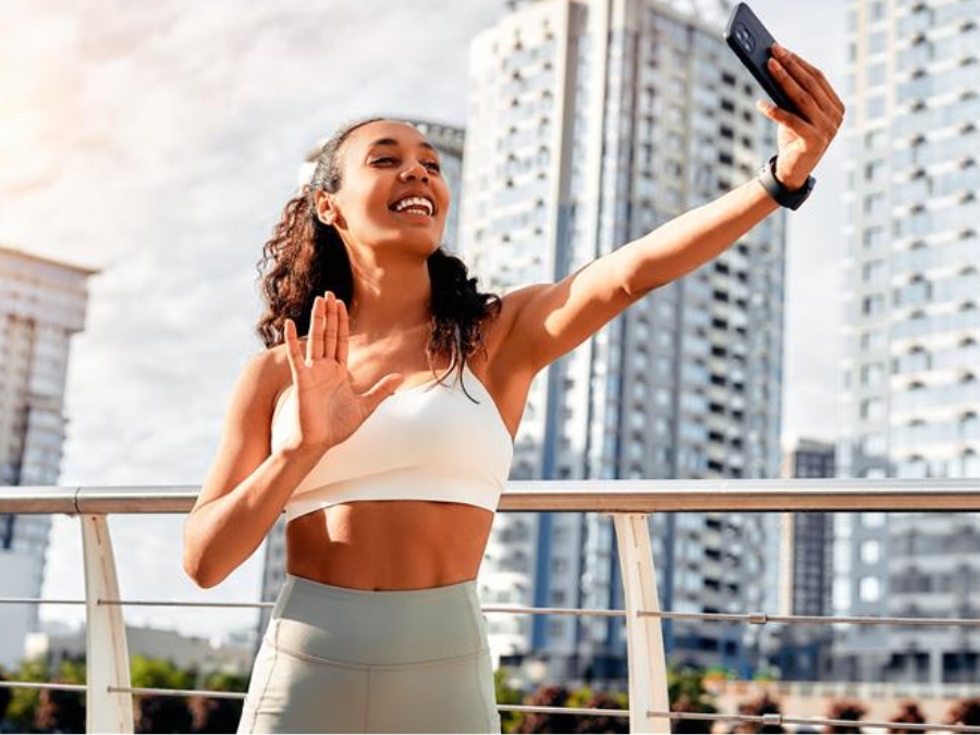 Fitness influencer taking a video outside