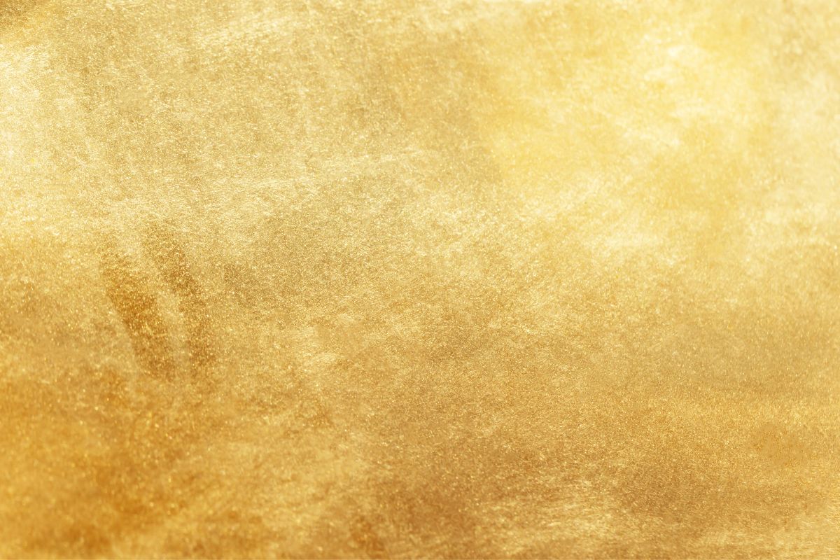 Shimmering gold textured background with metallic shine, ideal for luxury branding, elegant design, or golden abstract wallpaper.