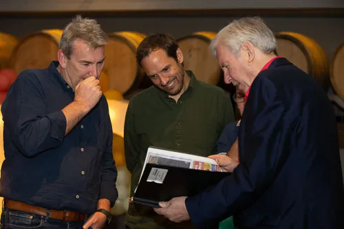 Leighton founders and CEO having a lighthearted conversation at Leighton's 30th birthday party.