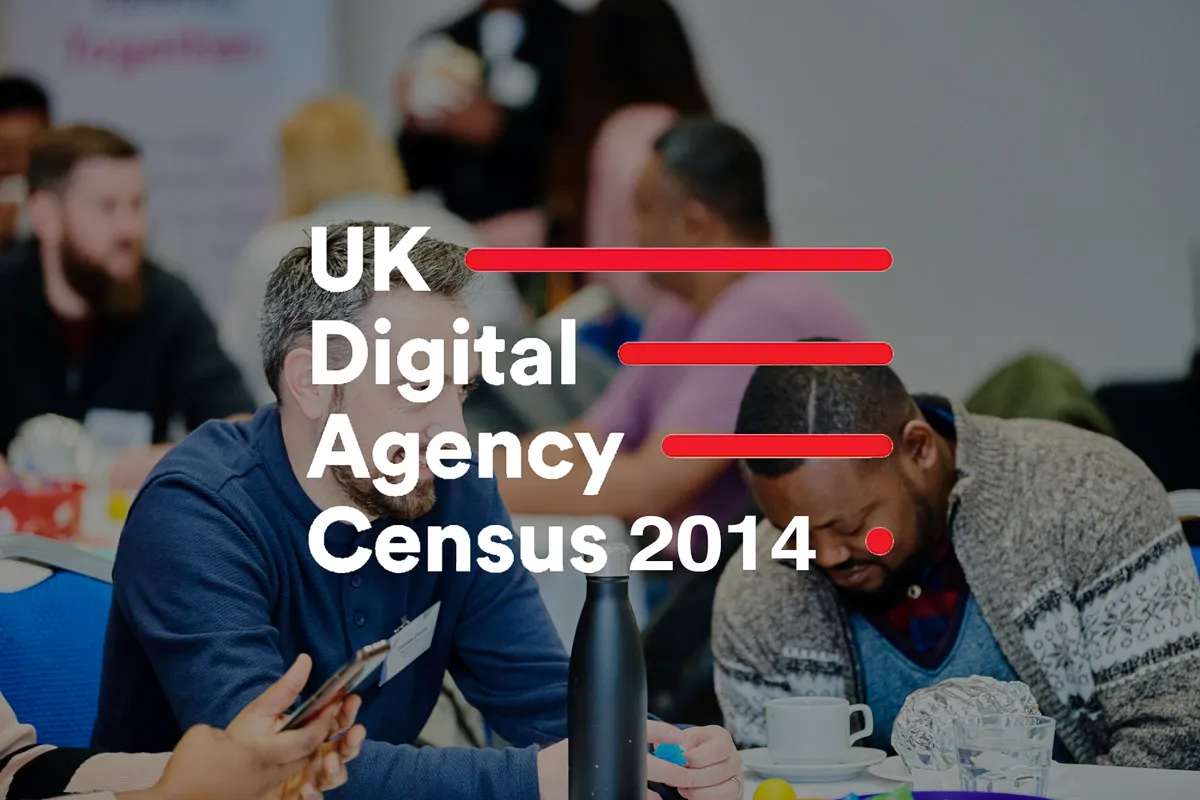 Colleagues engage in a focused discussion about achieving elite agency status in the Digital Census.