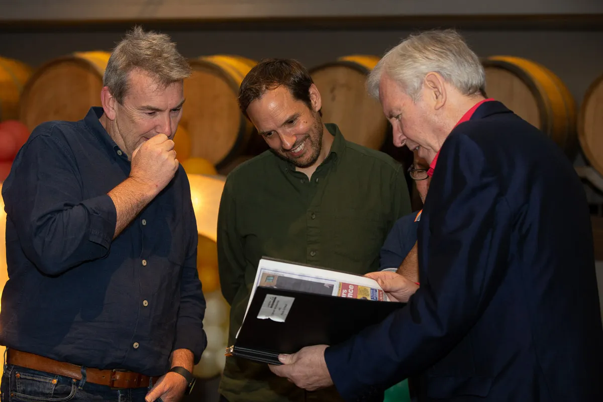 Leighton founders and CEO having a lighthearted conversation at Leighton's 30th birthday party.