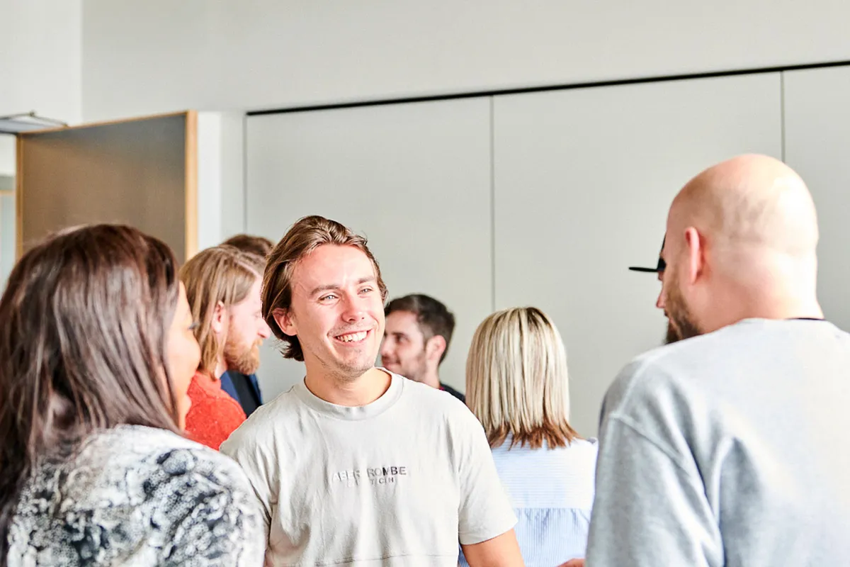 Colleagues engaged in a lively discussion about the Great Place to Work certification.