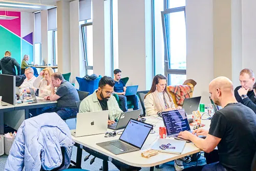 Multiple colleagues working in the office environment.