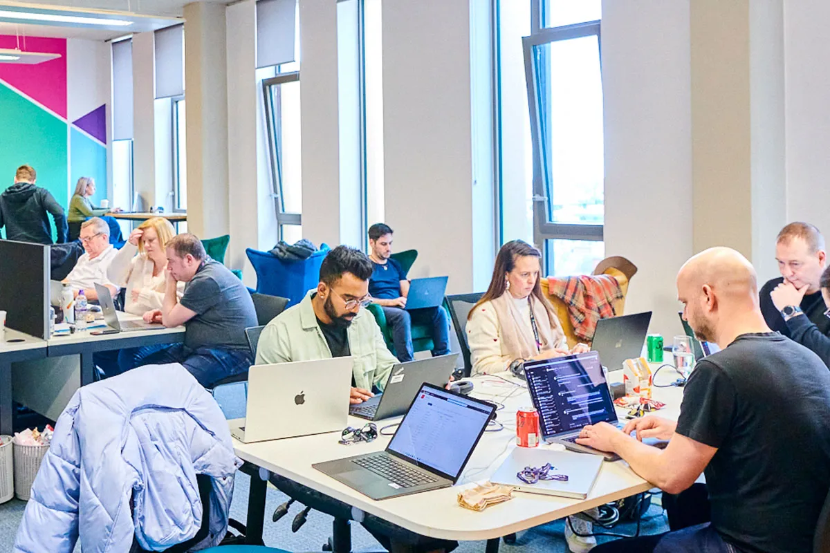 Multiple colleagues working in the office environment.