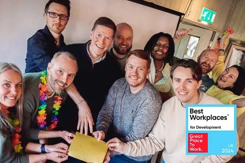 Leighton colleagues together all holding up Leighton's award for being one of the best places for development in 2024. 